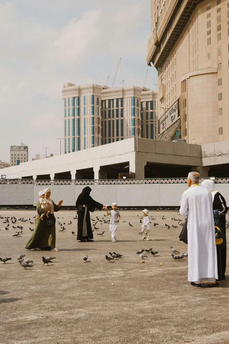 Pilgrims and families in the courtyard of Masjid an-Nabawi, Madinah